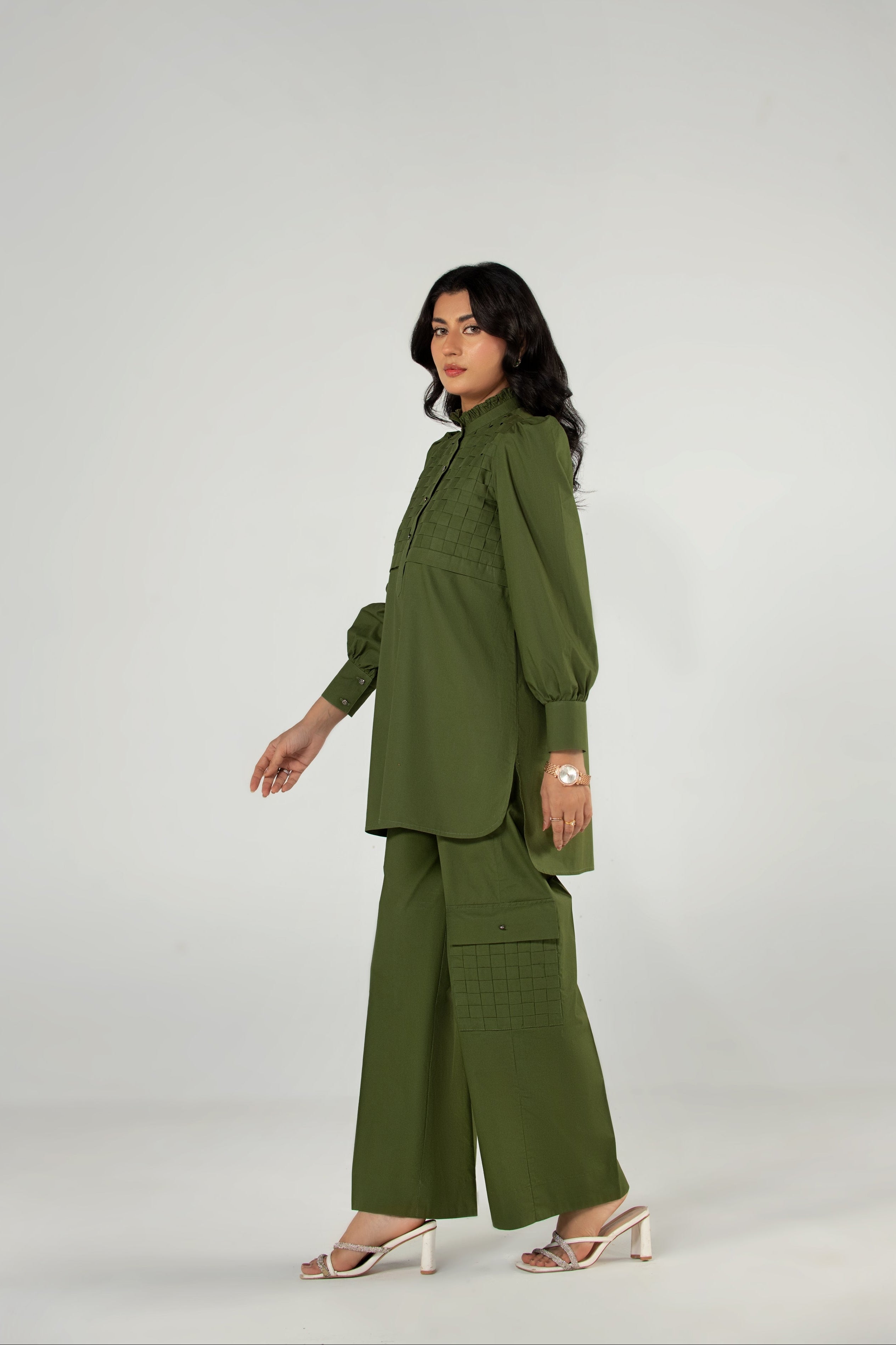 Woman wearing a green outfit on a white background