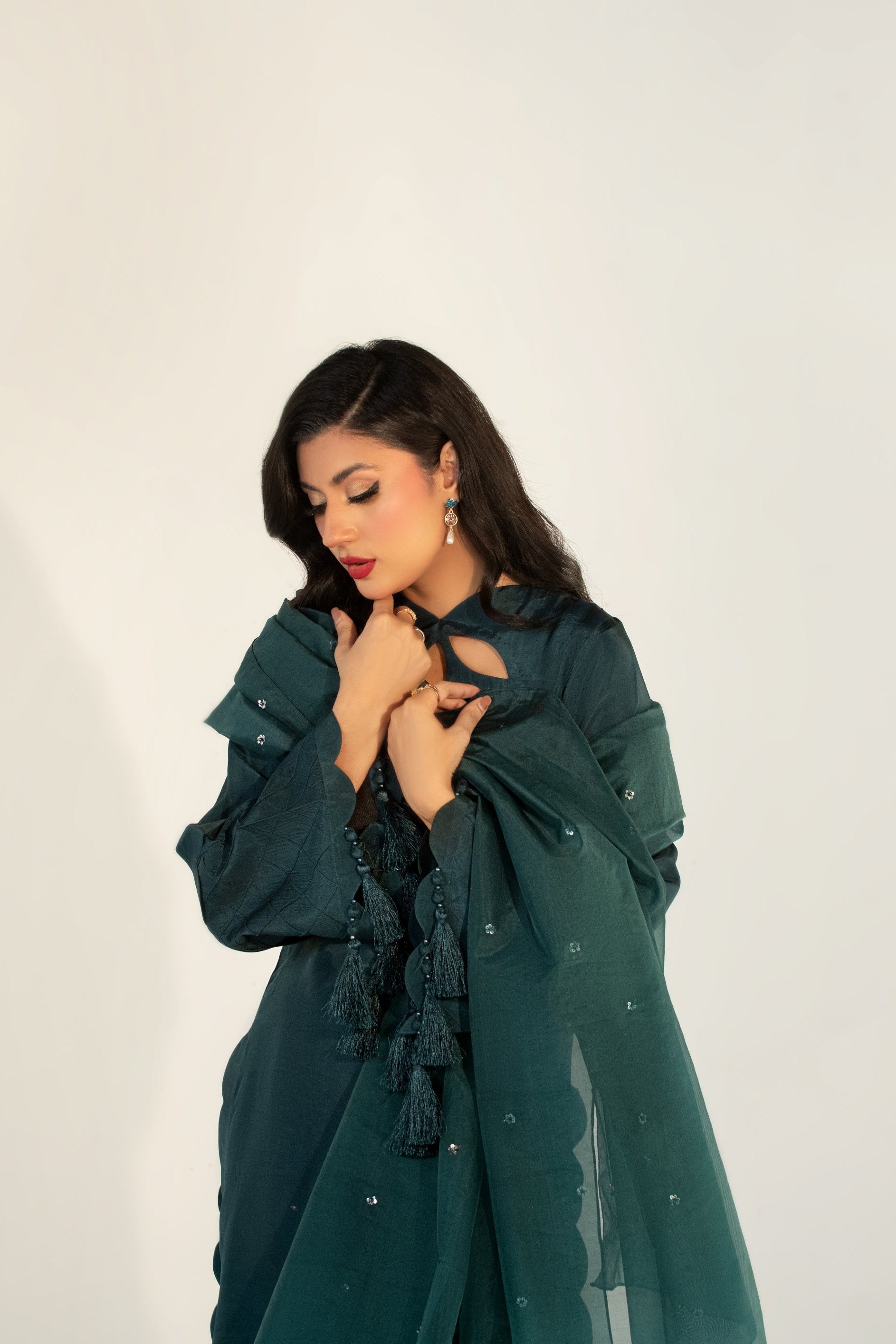 Woman wearing a green outfit against a white background